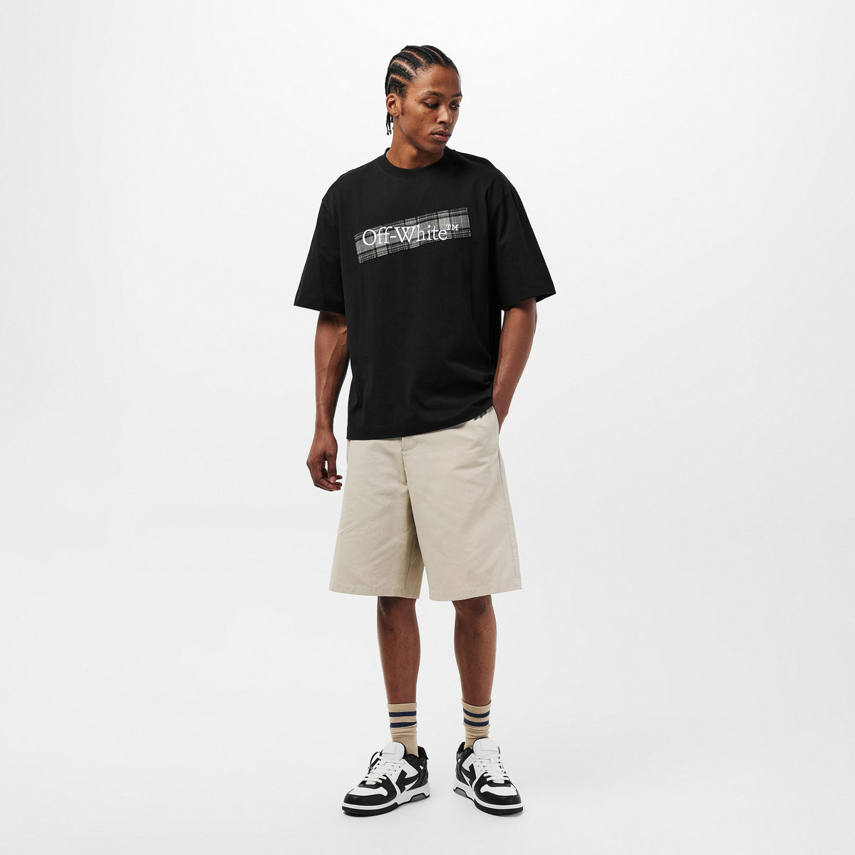 Black Off-White T-shirt with small chest logo, styled with light shorts and sneakers