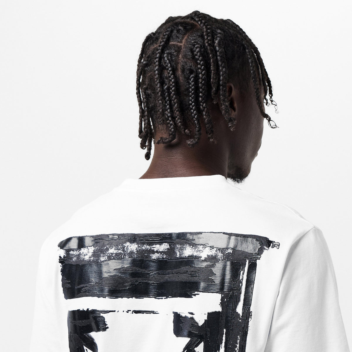Back of off-white T-shirt close-up: black ink arrow graphic