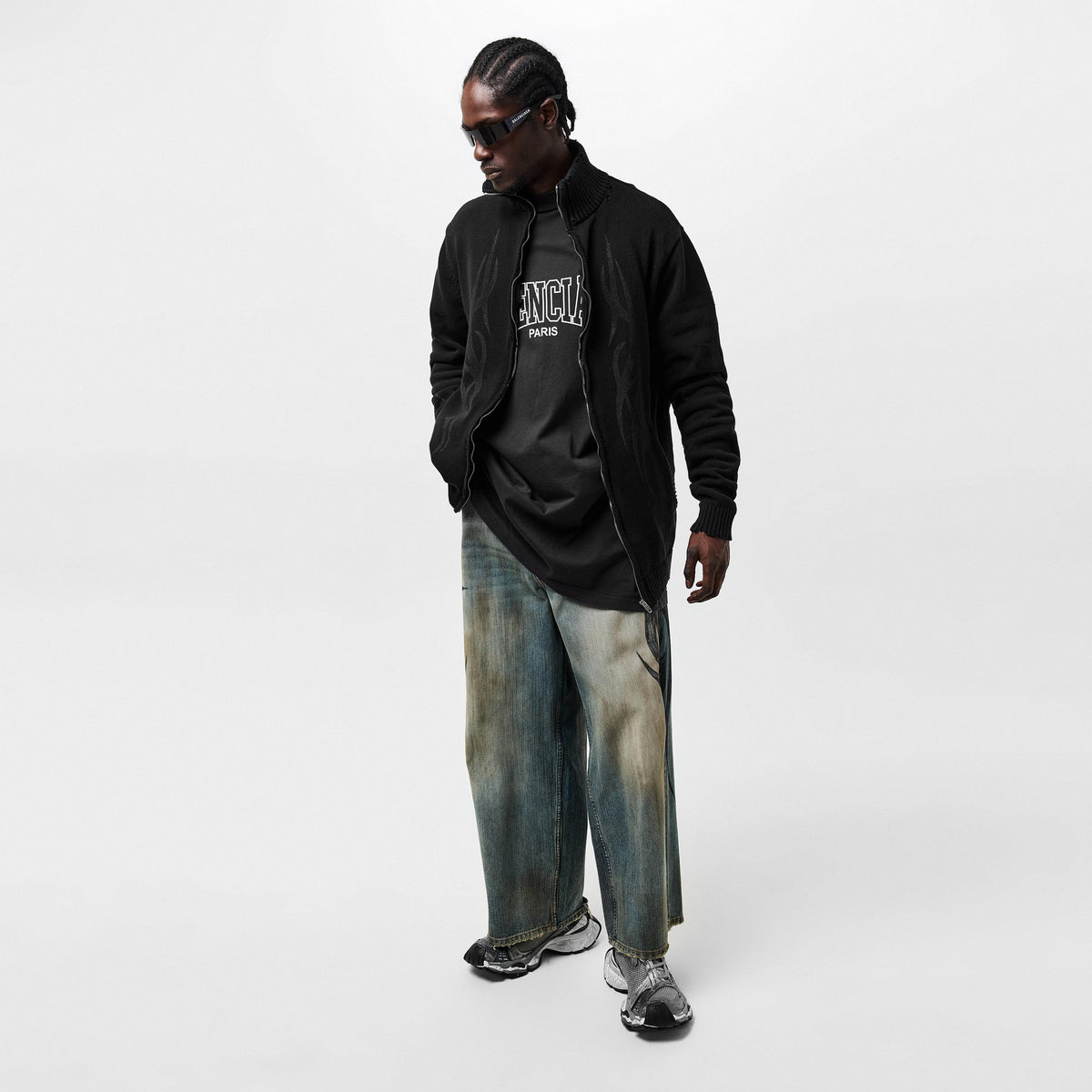 Black oversized T-shirt with small chest logo print, visible under zip knit hoodie