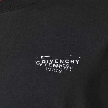 Close-up: black T‑shirt with white "GIVENCHY PARIS" logo stamp print