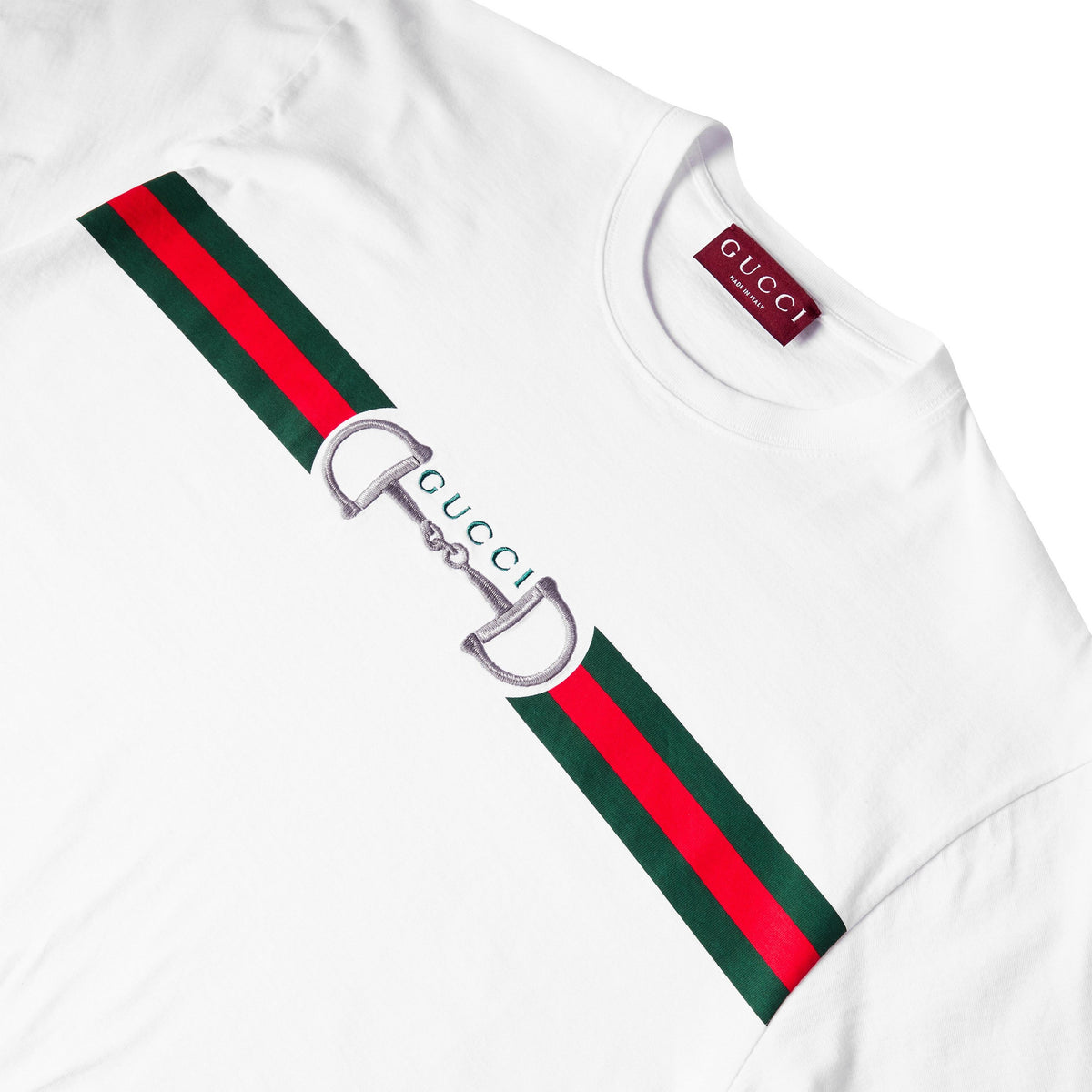 Close-up: white T-shirt neck label and green-red striped Gucci graphic detail