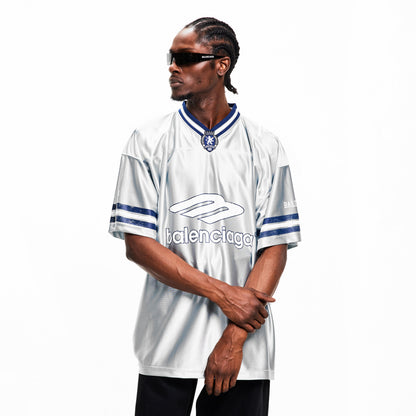 Men’s oversized Balenciaga T-shirt on model, white with blue logo and striped sleeves