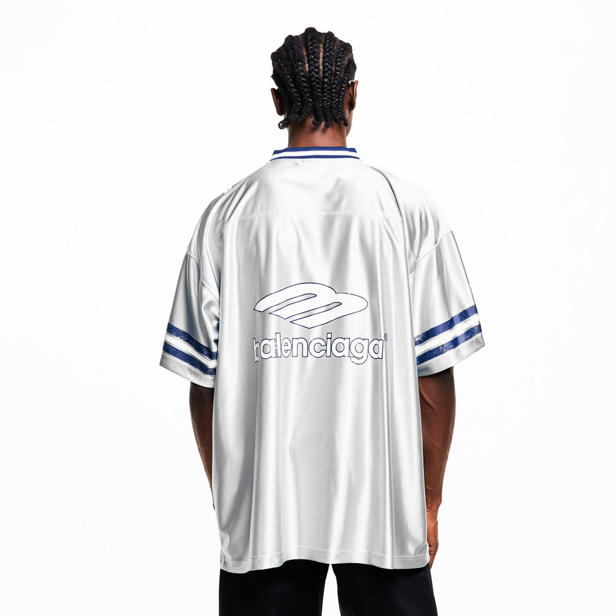 Model back view: oversized Balenciaga T-shirt, white with blue logo and striped cuffs
