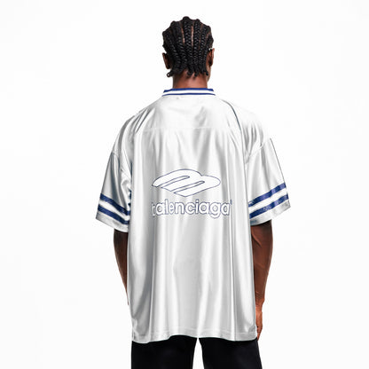 Model back view: oversized Balenciaga T-shirt, white with blue logo and striped cuffs