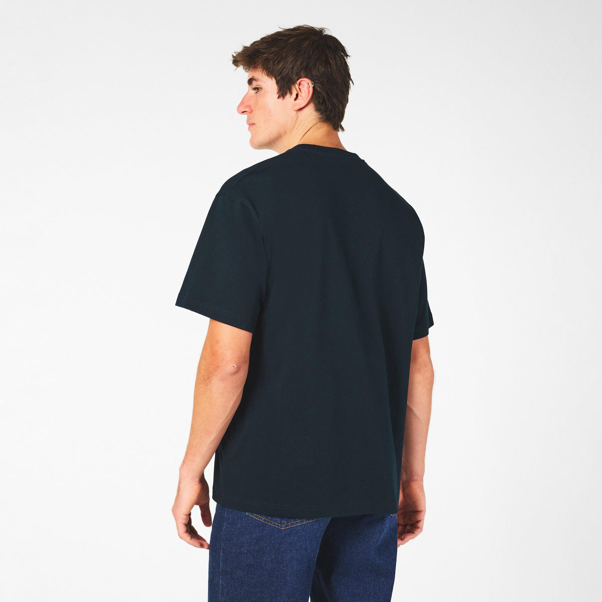 Men's dark T-shirt back view on model, crew neck, no front graphic visible