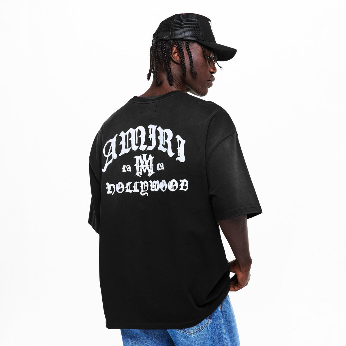 Back view: black oversized T-shirt with white graphic text across shoulders