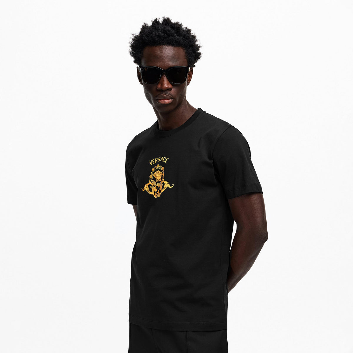 Black T-shirt with gold Medusa crest logo, front view