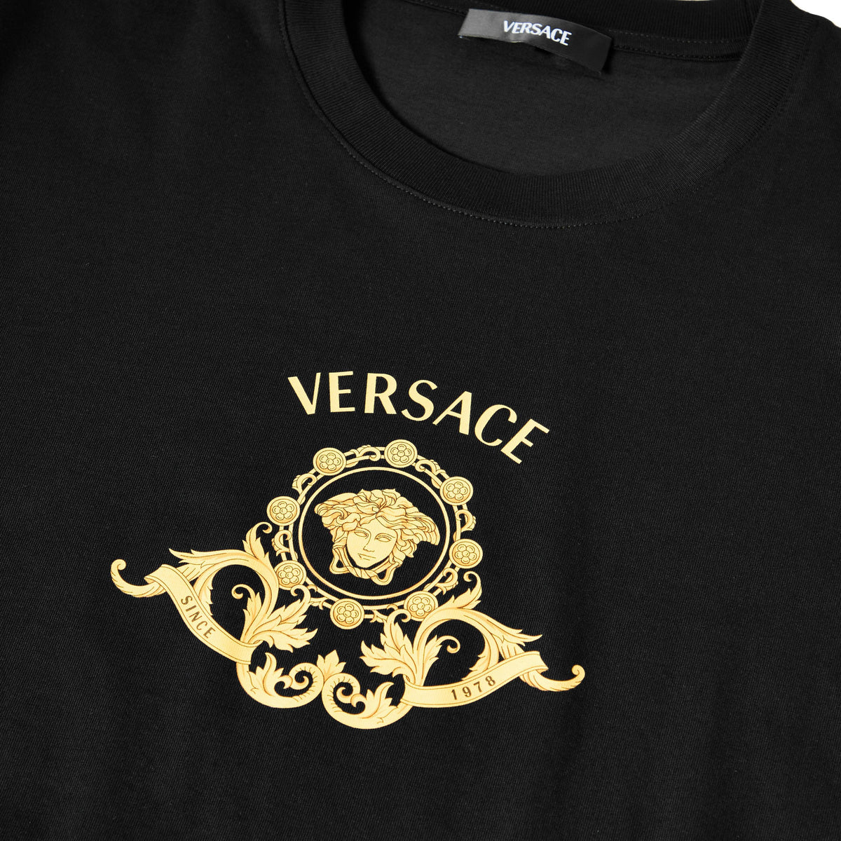 Black crew-neck T-shirt with gold Medusa crest and VERSACE text