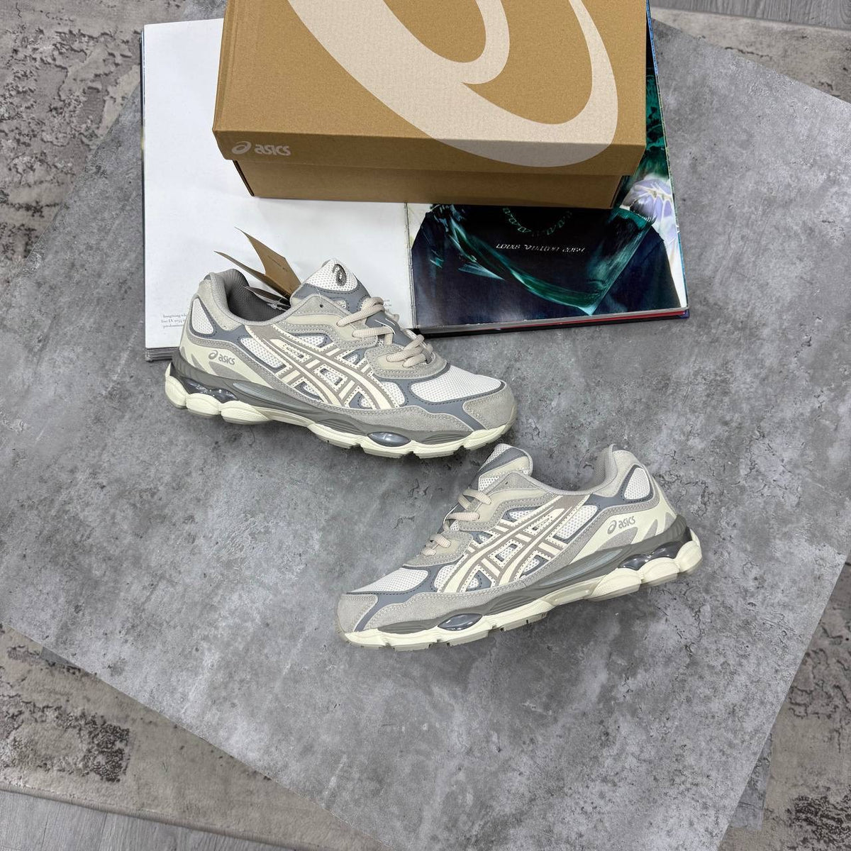 ASICS running shoes in gray and off-white with white laces and cushioned sole