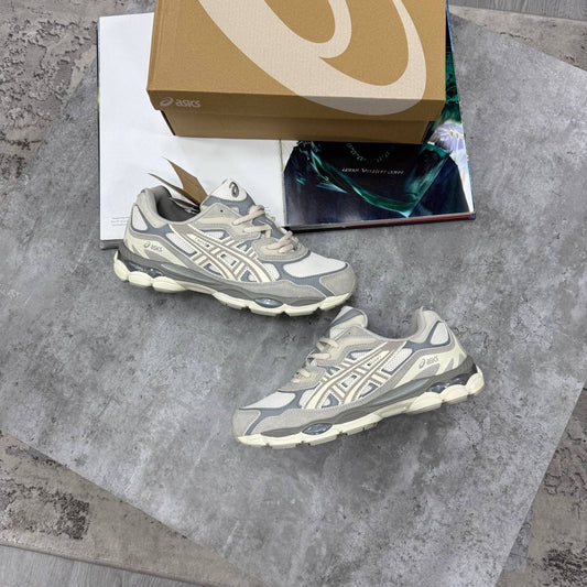 ASICS running shoes in gray and off-white with white laces and cushioned sole
