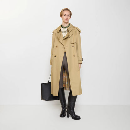 Long gabardine trench coat, tan color, open lapels with belt buckle and side pockets