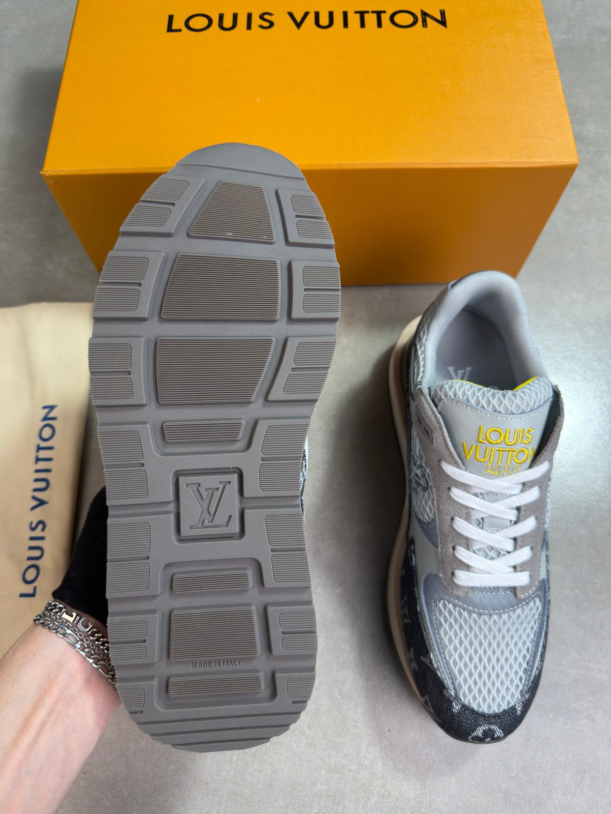 Grey Louis Vuitton trainers, tread outsole close-up with white laces