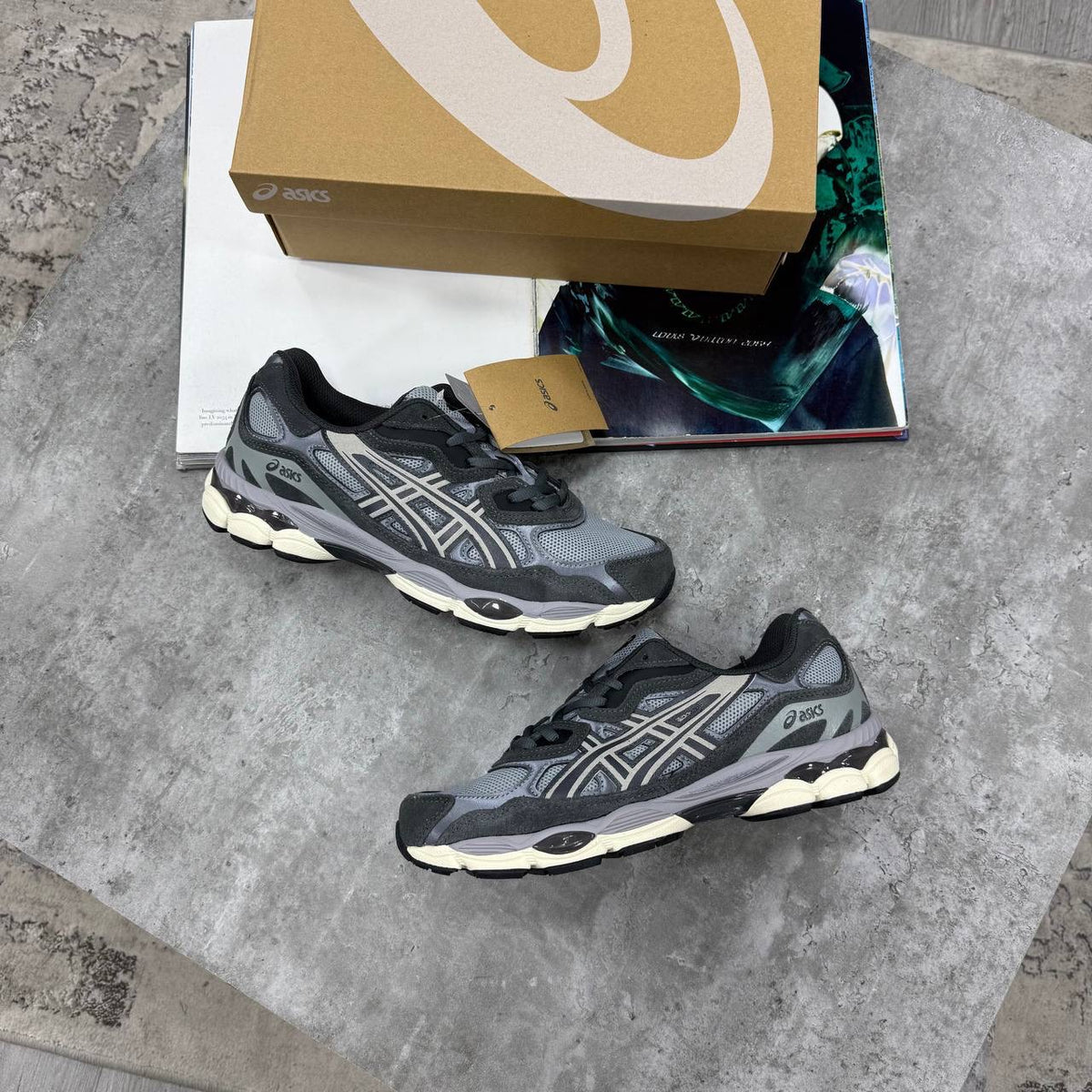 ASICS running shoes in dark gray and black with cream-toned midsole accents