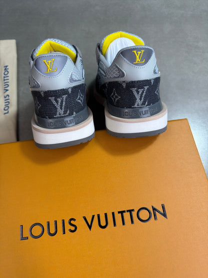 Grey Louis Vuitton trainers with yellow lining, back view showing heels