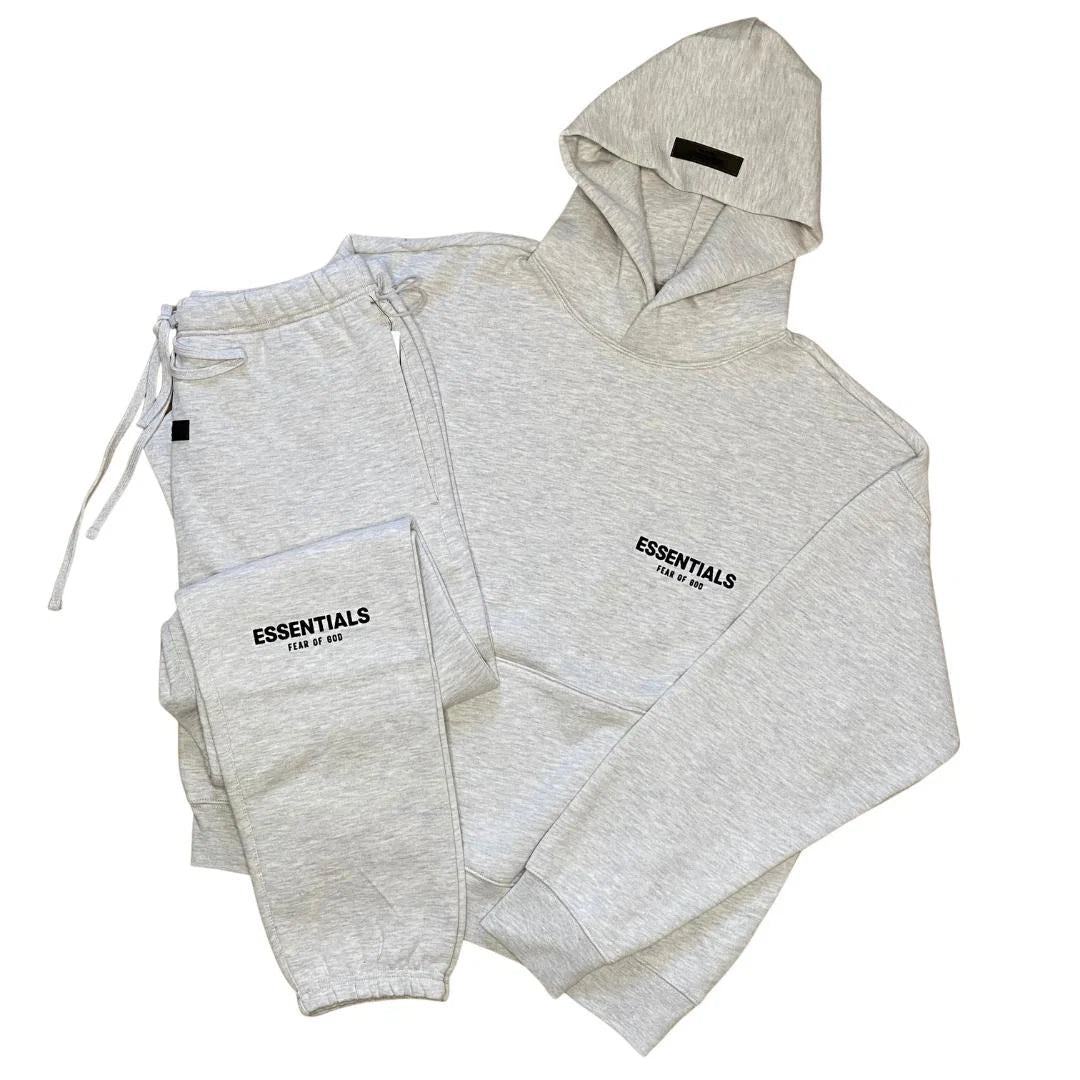Light grey tracksuit set with zip hoodie and joggers, ESSENTIALS logo on chest