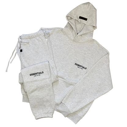 Light grey tracksuit set with zip hoodie and joggers, ESSENTIALS logo on chest