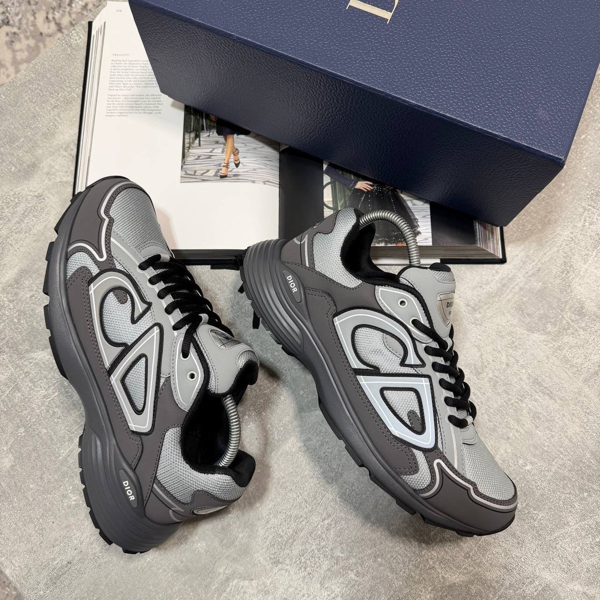 Gray lace-up stealth sneakers with black tongue, dark accents, and sculpted tread sole