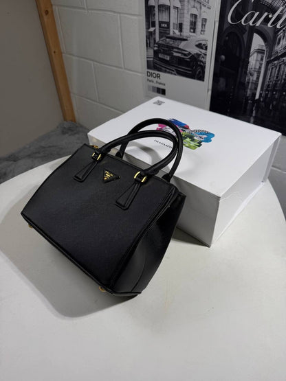 Black LV Alma BB-style handbag with top handles and detachable strap hardware