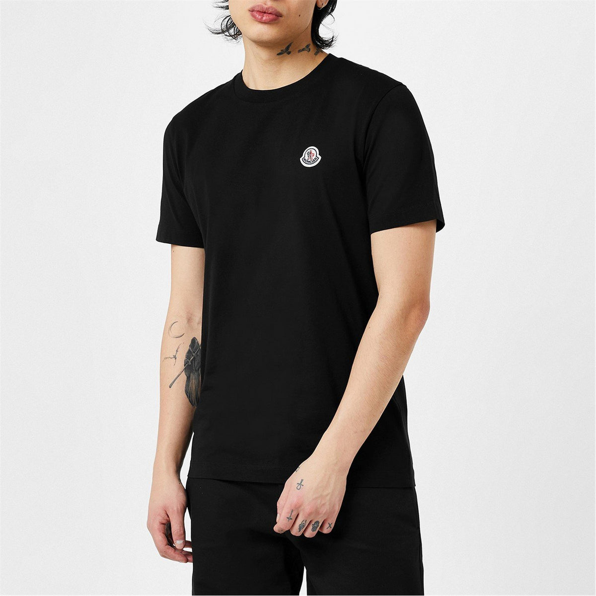 Black cotton T-shirt with small chest logo badge and short sleeves