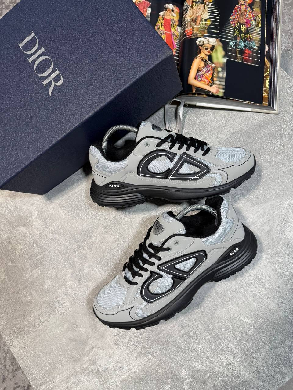 Lace-up stealth sneakers in light gray and white with black eyelets and chunky sole