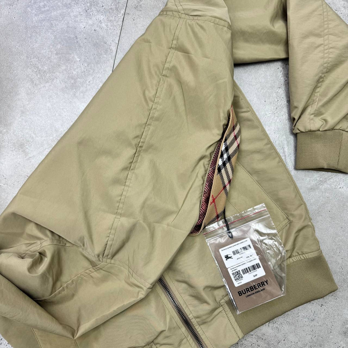 Beige Harrington jacket with Burberry check collar, zip front, side pockets