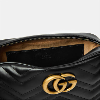 Black GG Marmont bag interior lining with stitched logo area and gold-tone GG hardware.