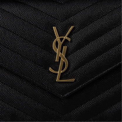 Close-up: black quilted envelope flap with gold YSL monogram logo