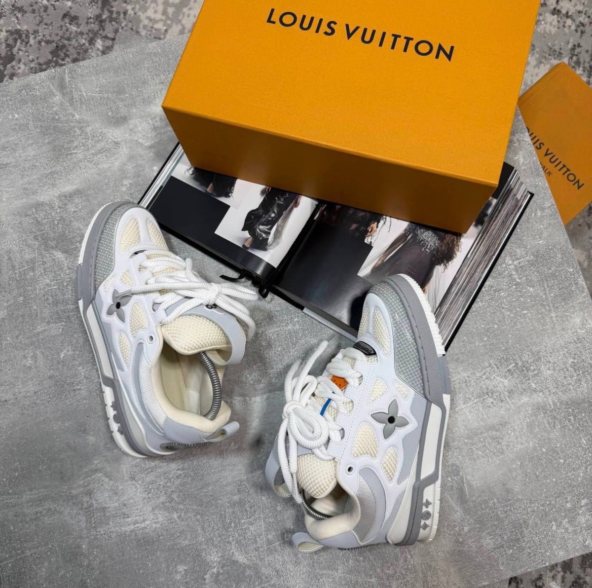 White skate sneakers with gray sole, beige laces, logo flower emblems