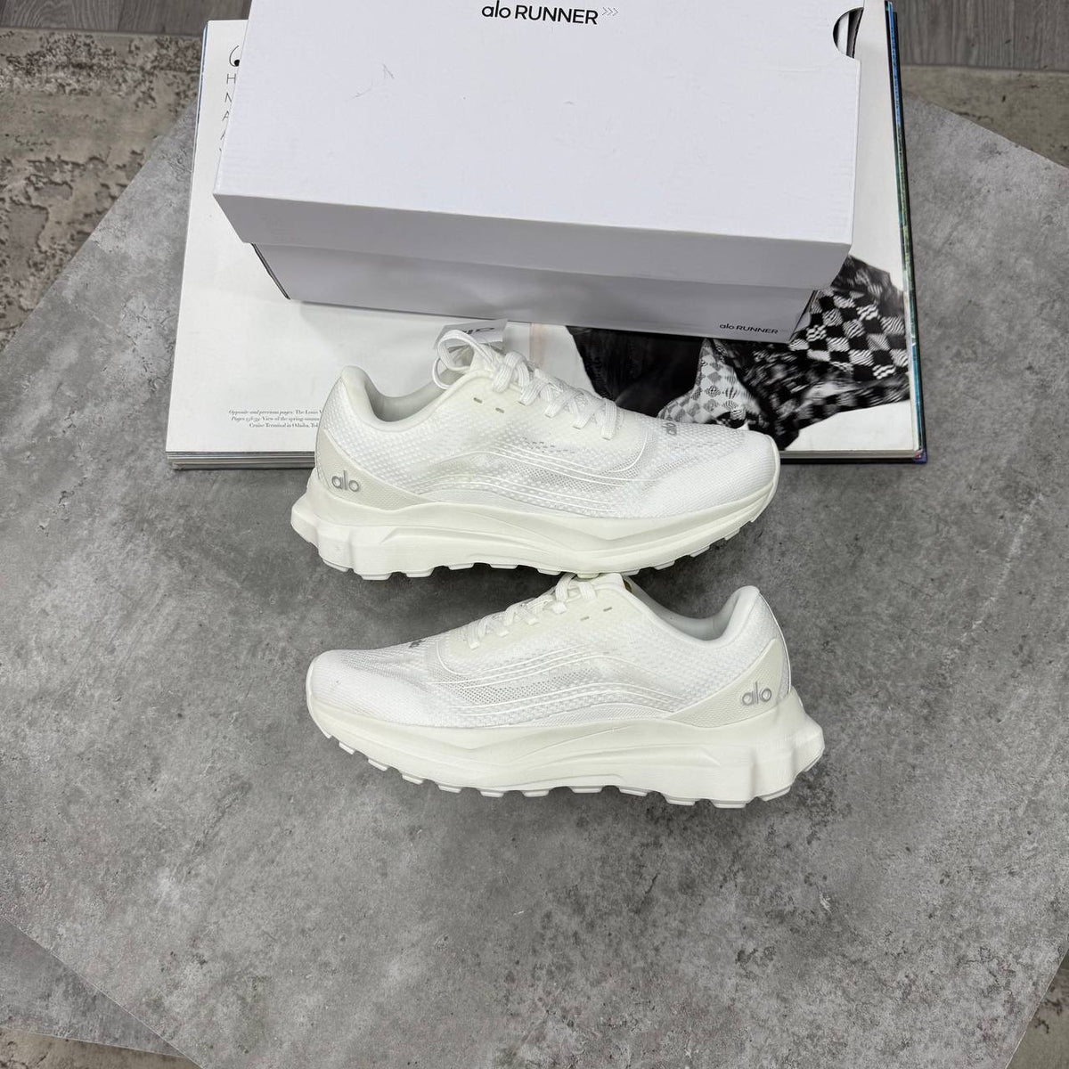 White lace-up training shoes with mesh-like texture and thick treaded sole