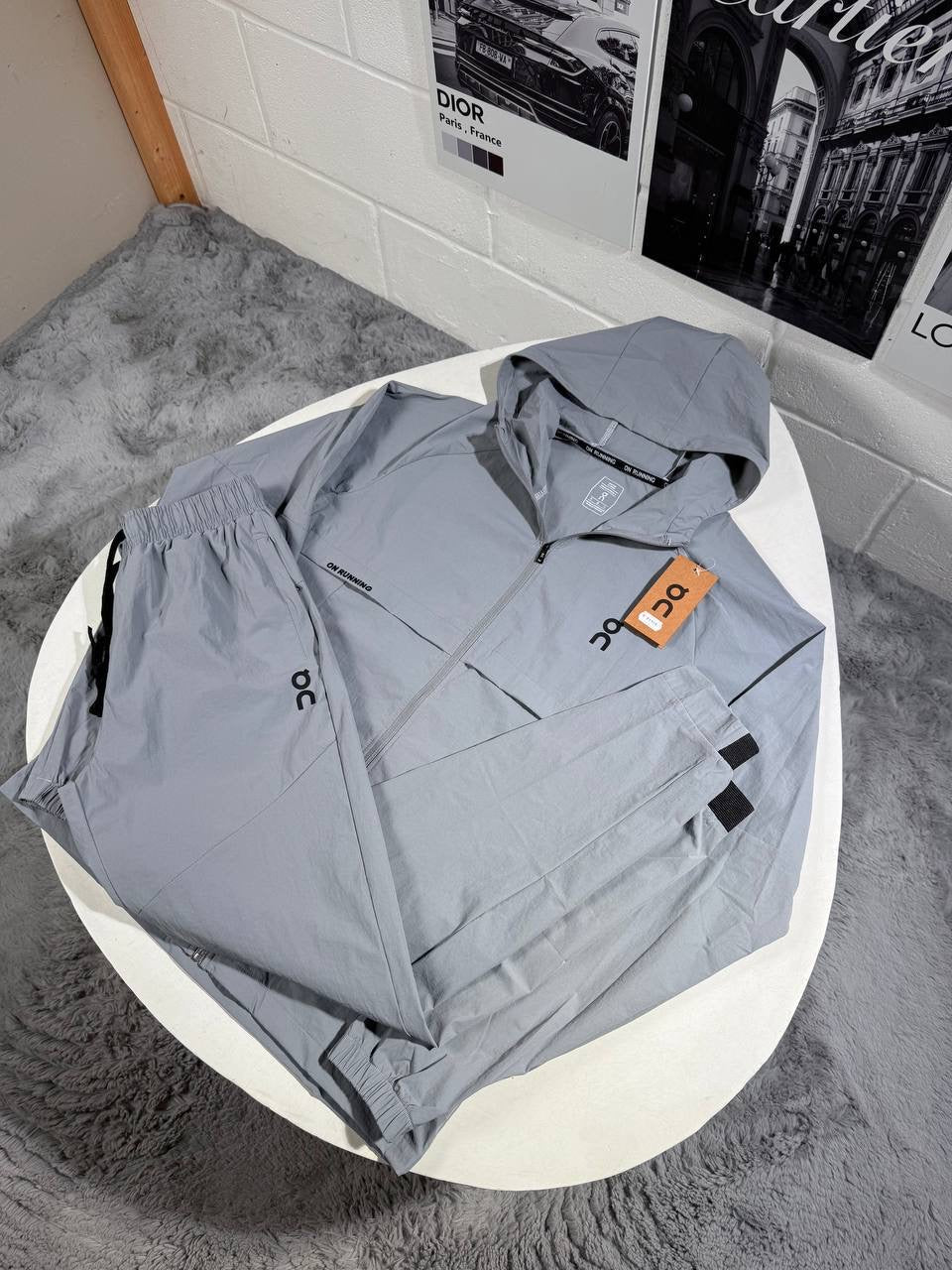Hooded zip tracksuit jacket in light blue with logo patch and orange tag