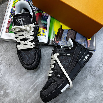 Black LV trainers with monogram print, white laces, and side emblem on strap.