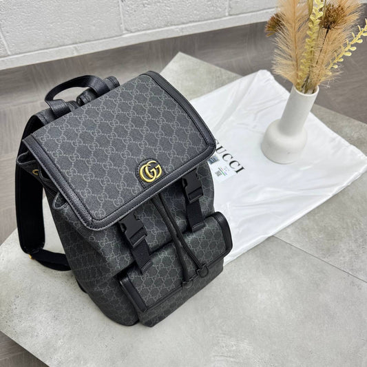 Dark gray GG monogram backpack with front flap, buckle closures, and shoulder straps