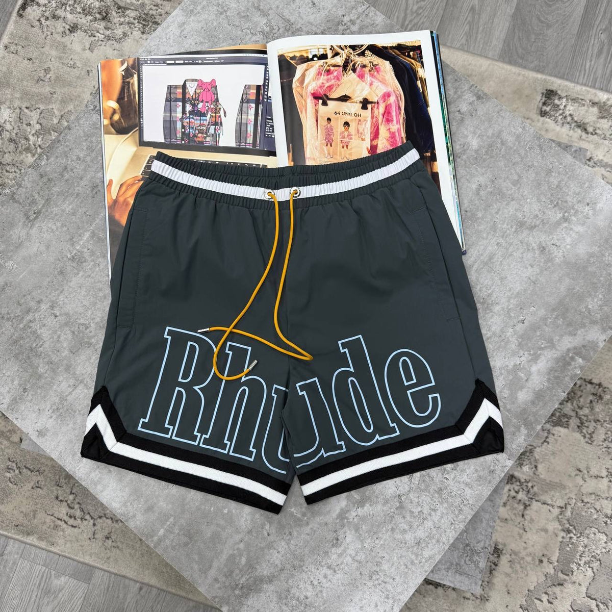 Rhude dark grey drawstring shorts with elastic waistband and white striped hem