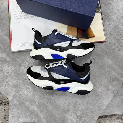 Black and blue low-top trainers with chunky white sole, lace-up and mesh panels