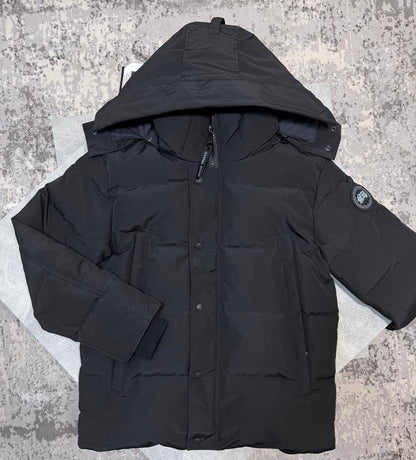 Black CG coat with structured hood, front zipper, and sleeve logo patch