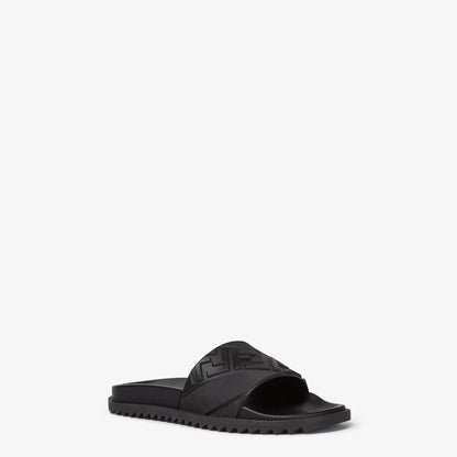 Black rubber slides, side view, embossed pattern on the strap