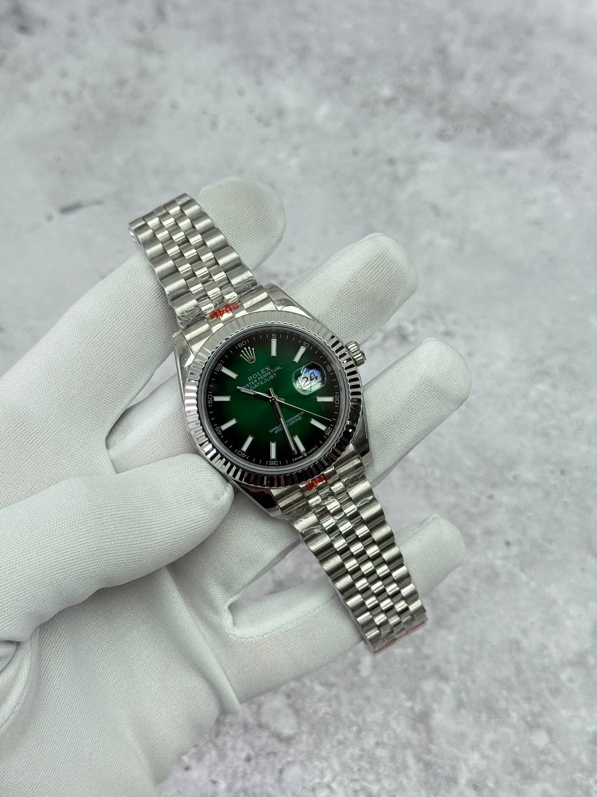 Rolex Datejust stainless-steel watch with green dial and bracelet, fluted bezel