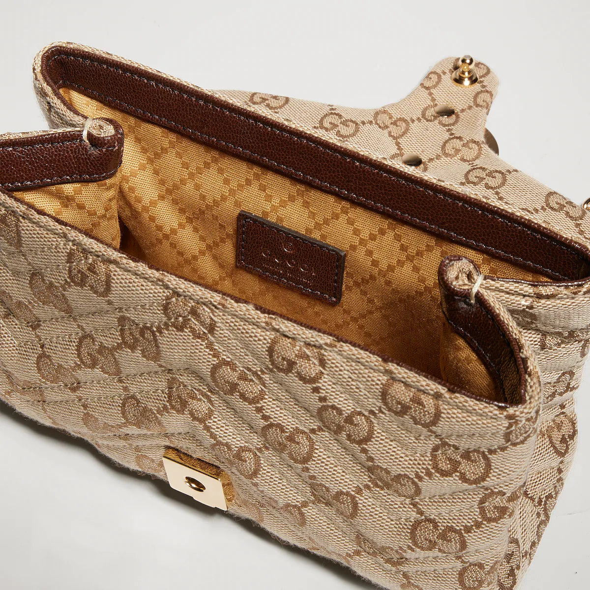 Beige GG Marmont mini shoulder bag interior view with brown leather trim and logo snap