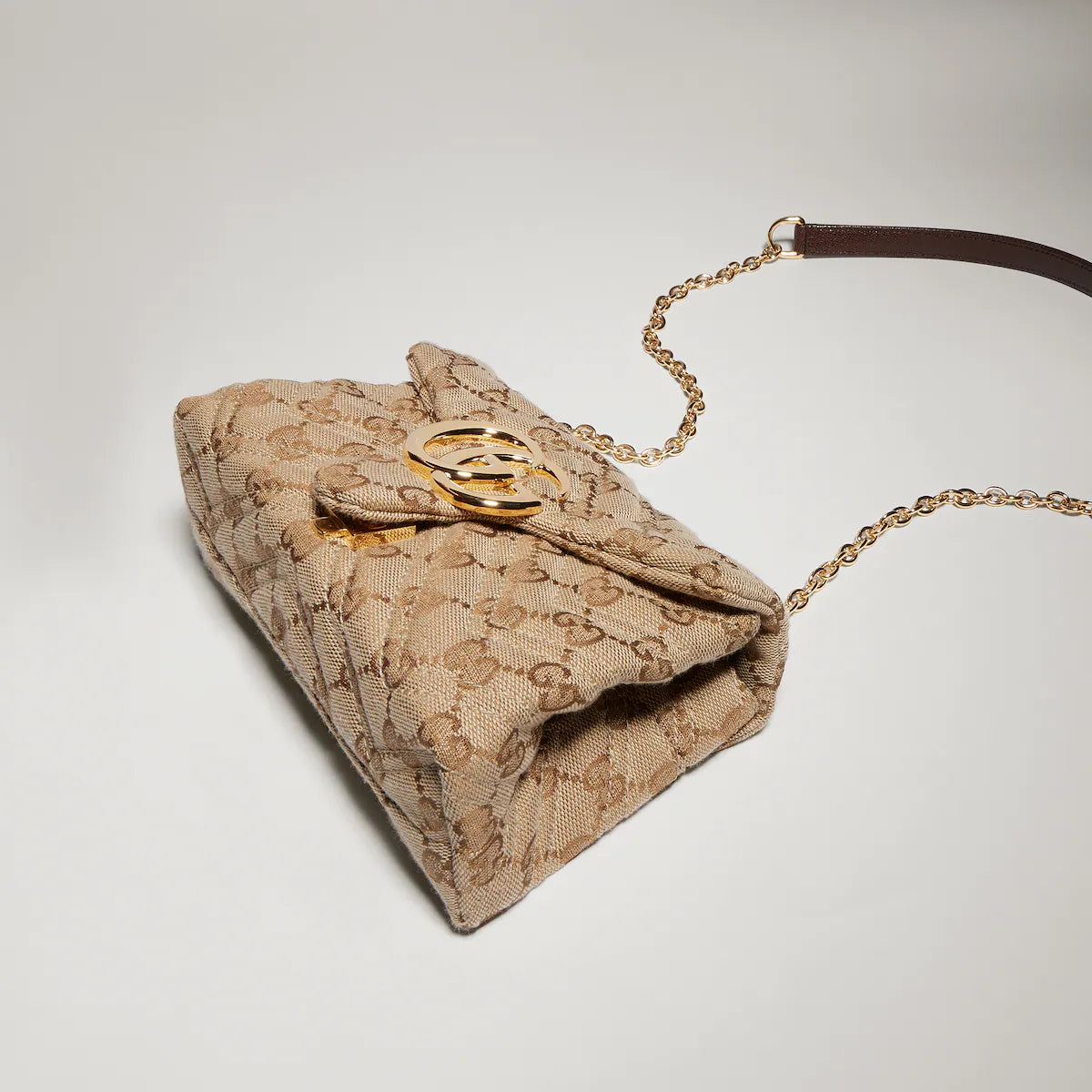 Beige GG Marmont mini shoulder bag underside with monogram canvas and gold hardware detail