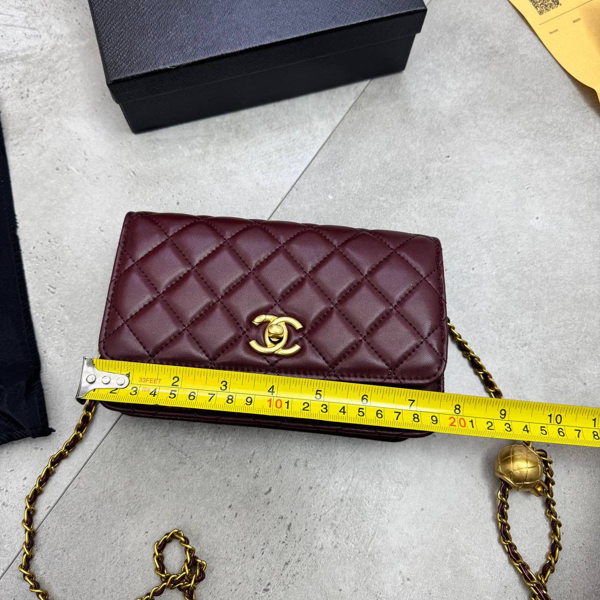 Burgundy quilted flap bag with gold-tone CC logo and chain strap