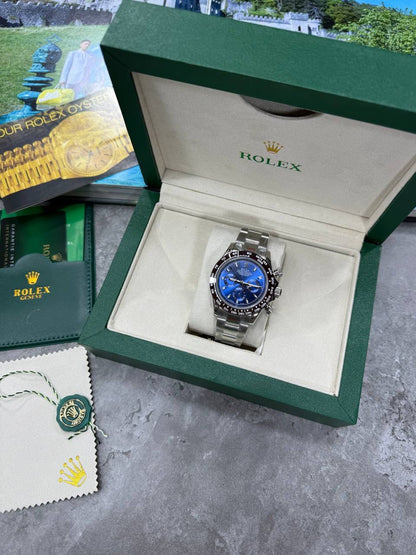 Rolex blue dial chronograph on silver bracelet, displayed in green gift box