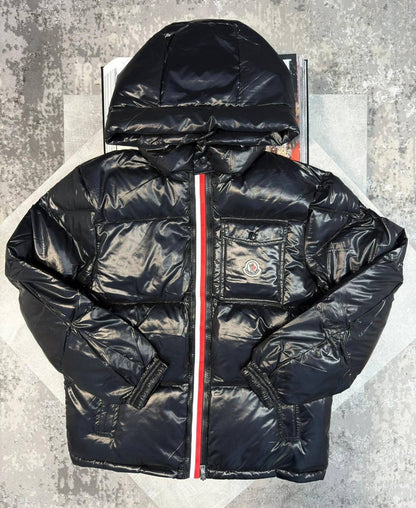 Black puffer jacket with hood, front zipper, and chest logo patch