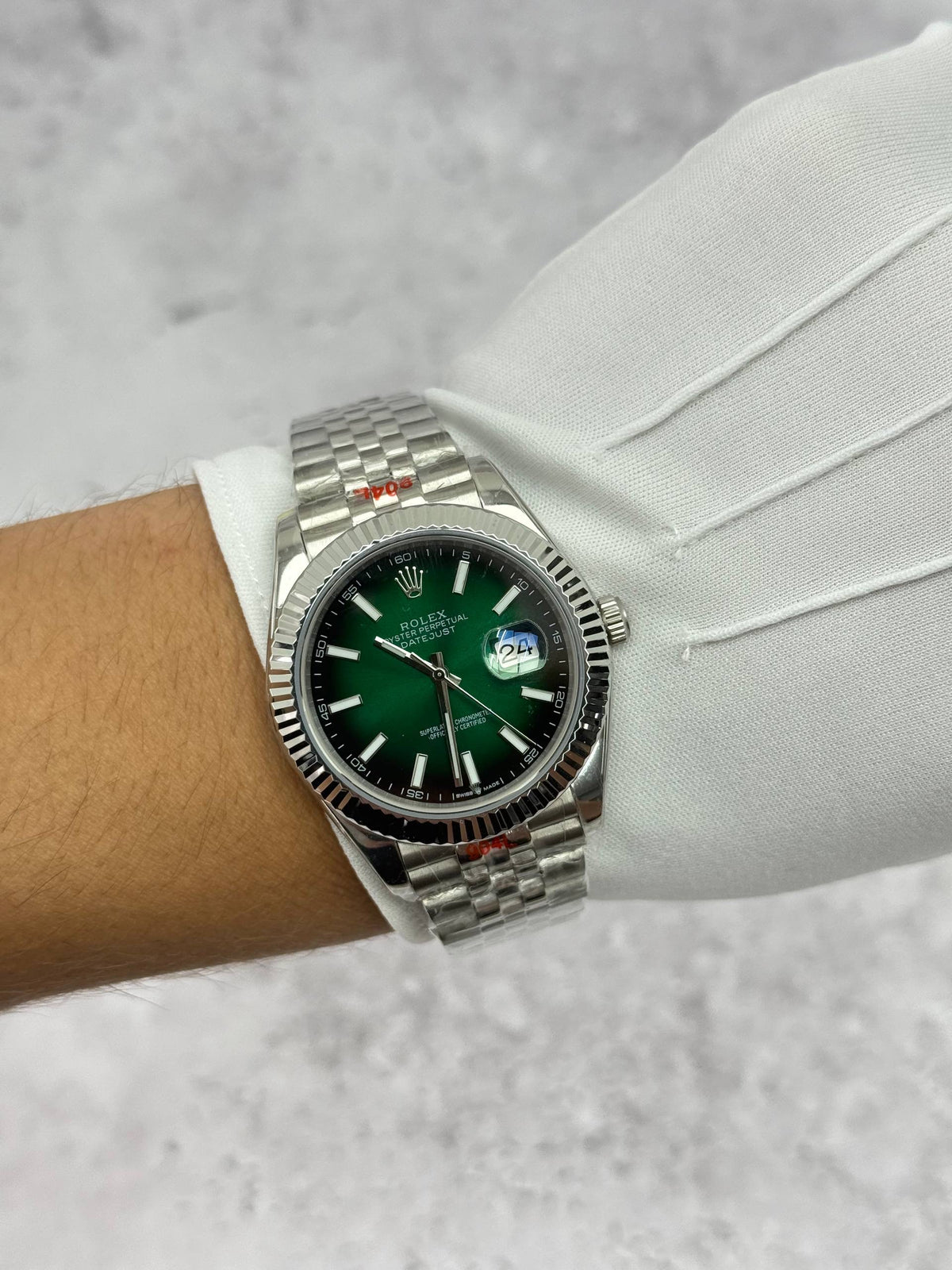 Rolex Datejust wristwatch on steel bracelet, green face with silver bezel details