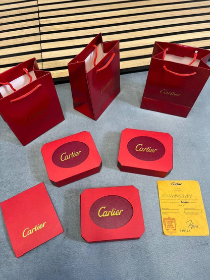 Red Cartier jewelry gift boxes and cards, bracelet not clearly visible