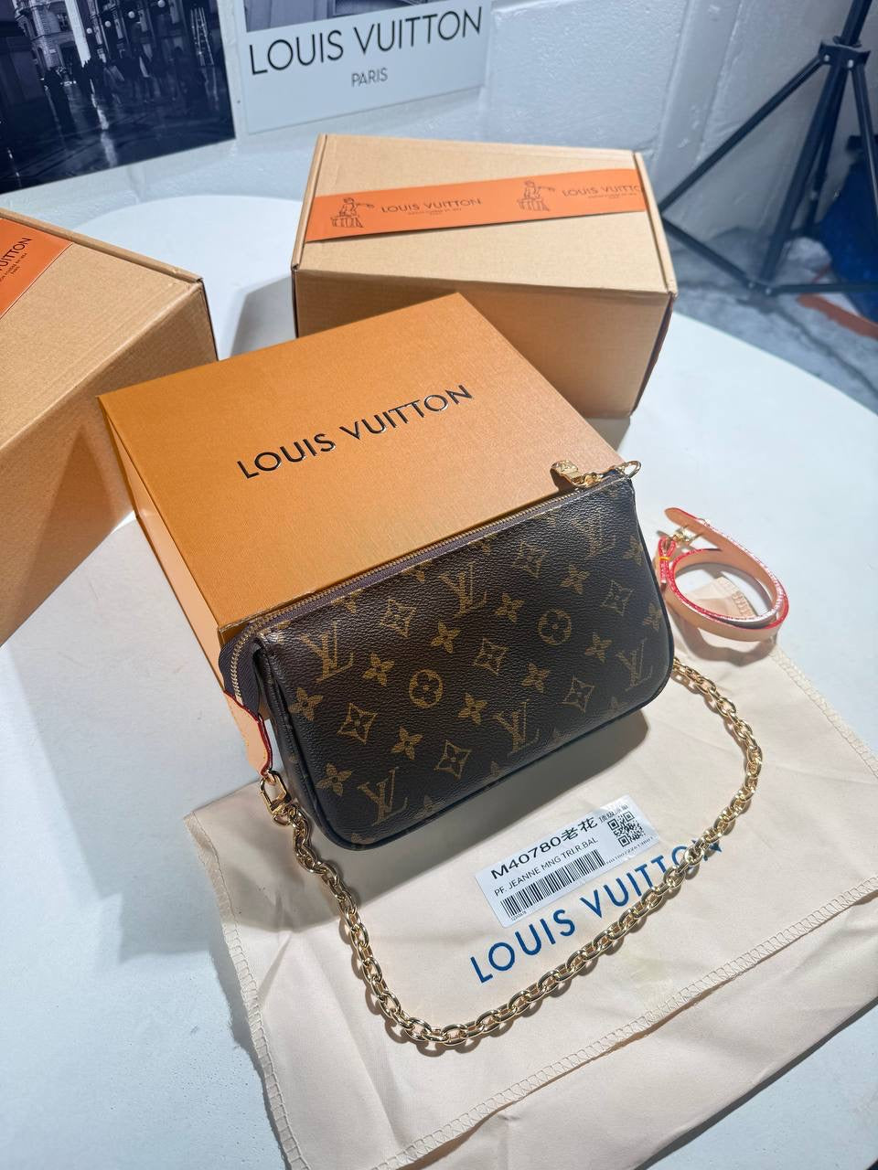 LV monogram pochette bag with gold chain strap, flap clasp, dark brown canvas