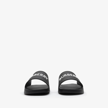 Schwarze Slides mit BURBERRY-Schriftzug auf dem Riemen