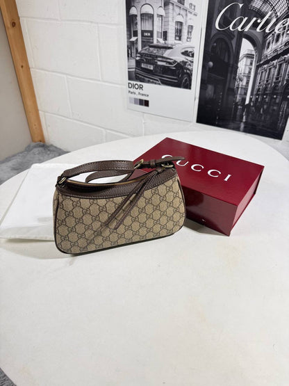 GG canvas handbag with short strap and red lining, brown monogram pattern