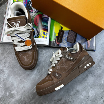Brown LV trainers with monogram print, white laces, and side strap detail.