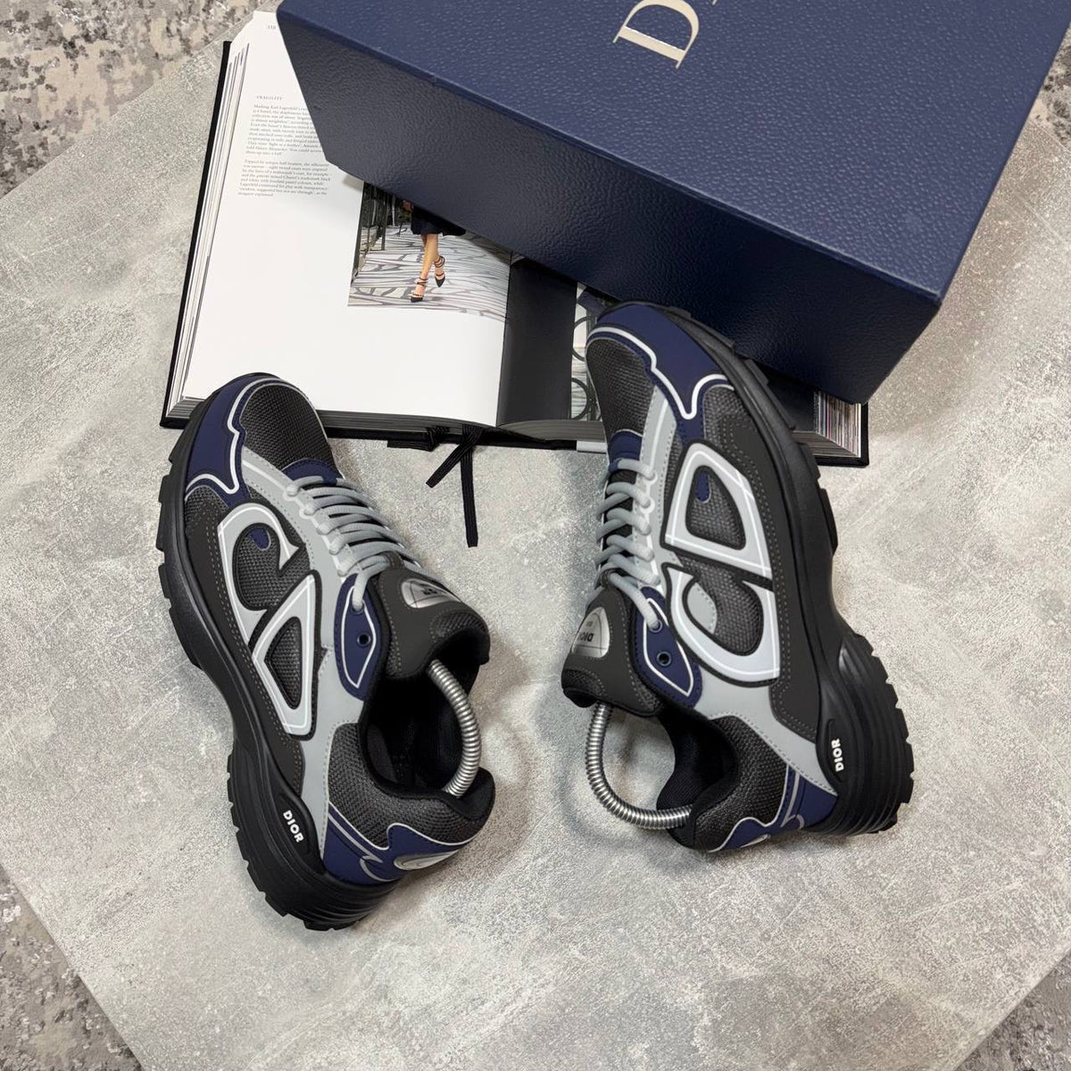 Chunky lace-up stealth sneakers in dark gray with blue trim and light gray panels