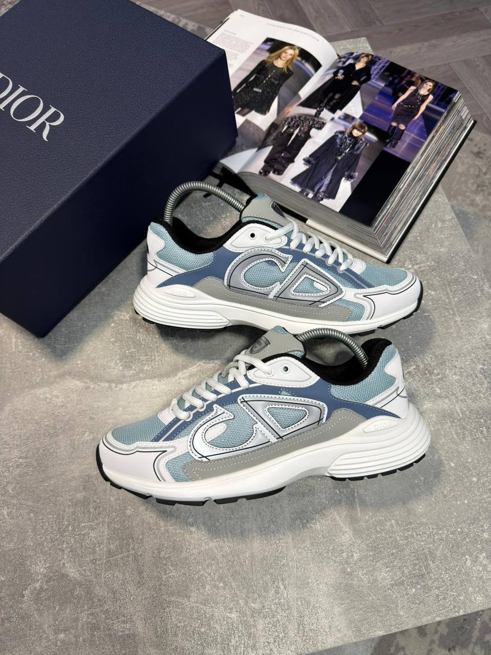 Light blue and white lace-up stealth sneakers with gray accents and chunky tread sole